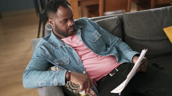 African man reading papers