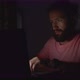 Young Bearded Man Working on Laptop in Darkness - VideoHive Item for Sale