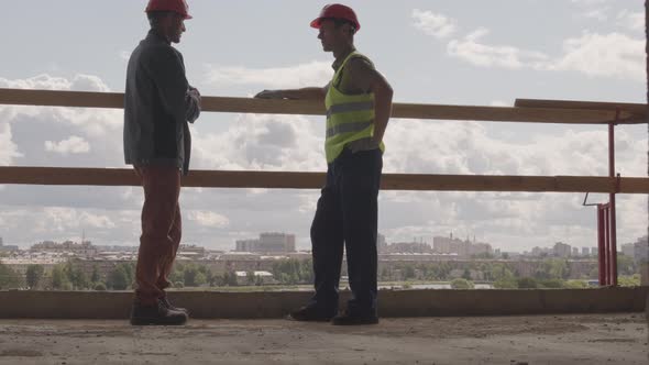 Construction Workers in Building Frame