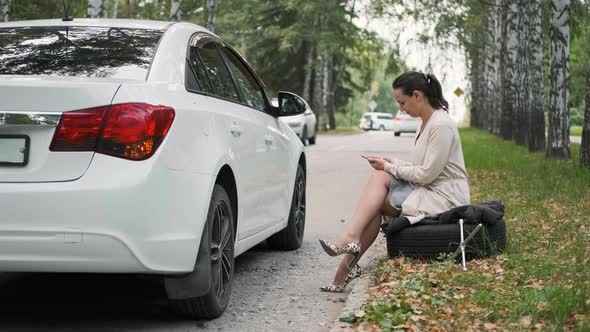 Woman Looking for Info on How to Change a Wheel