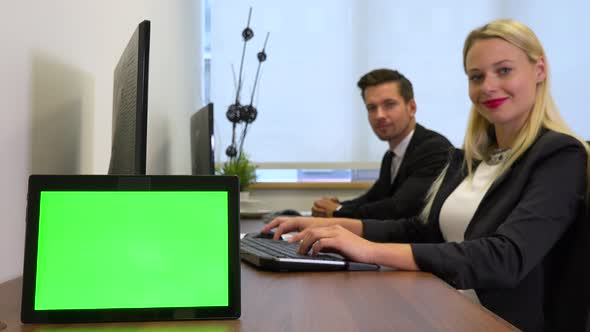 Two Office Workers Work on Computers, Then Smile