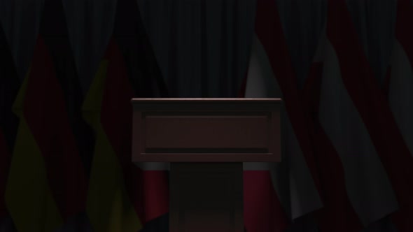 Many Flags of Austria and Germany Behind Speaker Tribune alt