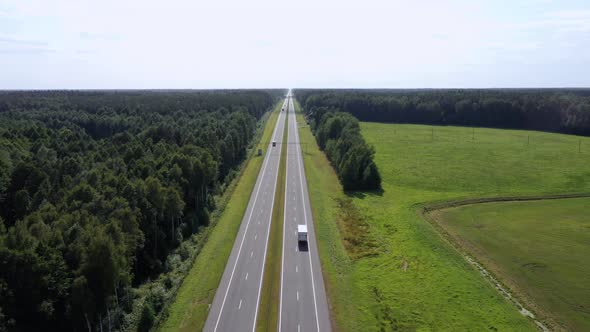 Trucks Driver With Trailer Carrying Cargo On Speed Intercity Highway Aerial View