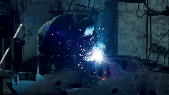 Heavy Industry Welder Welds Metal Parts for Car Repair