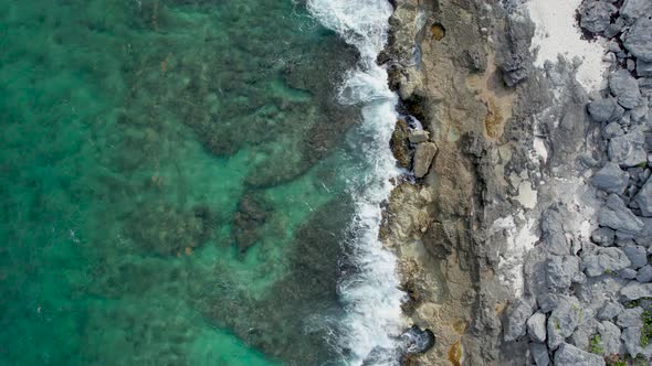 Shot of the Caribbean waves breaking on the rocks with a turquoise sea.Video taken in the Riviera M