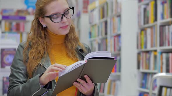Portrait Close Up of Happy Pretty Young Woman, Girl in Glasses Student Reading in Book Library
