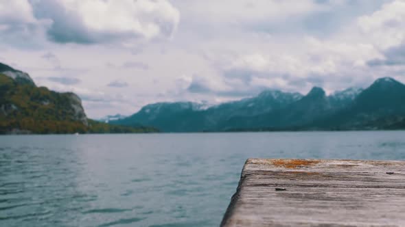 Wooden Pier on the Background of a Mountain Lake and Snowy Alps, Austria, Wolfgangsee Lake