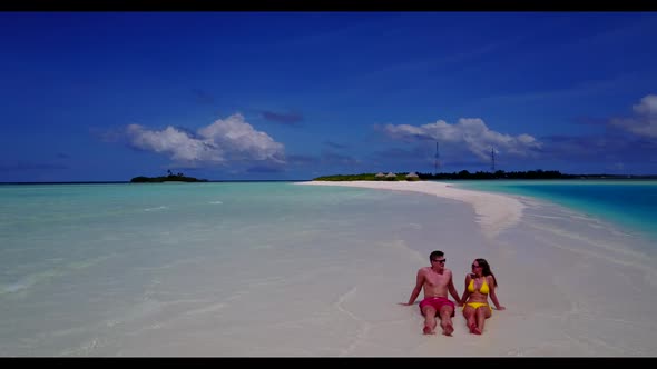 Man and lady in love on marine lagoon beach voyage by aqua blue ocean and white sand background of t