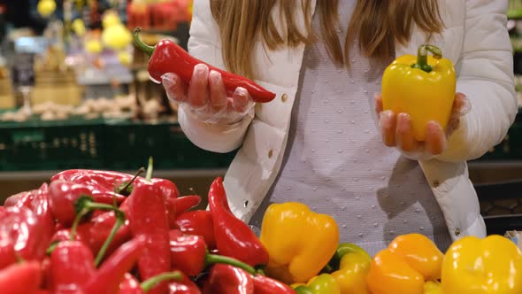 Vegetarian Woman Chooses Vegetables at the Market