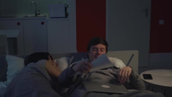 Couple in Bedroom Overworked Manager