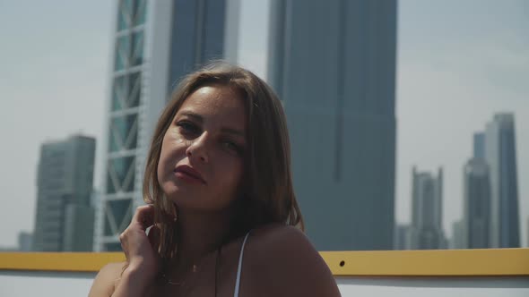 Girl in a White Bathing Suit is Sunbathing While Standing