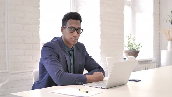 Serious Businessman at Work Looking at Camera