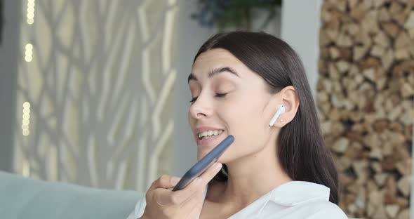 Woman Recording Audio Message or Podcast Using Smartphone Staying Home