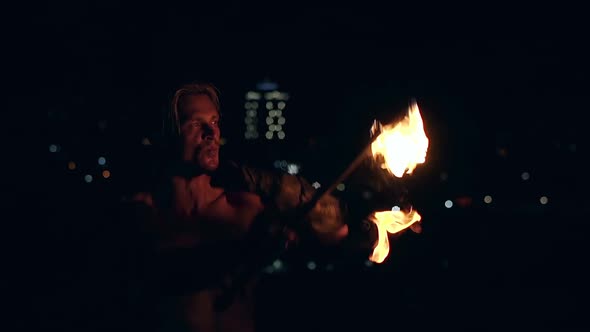 Young Blond Male Breathes Out Large Stream of Fire Making Fireball. Slow Motion