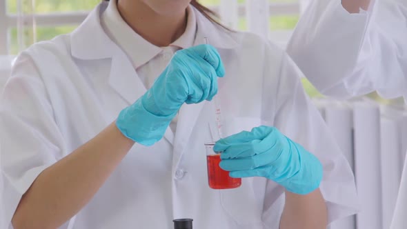 Scientist Work with Science Equipment in Laboratory