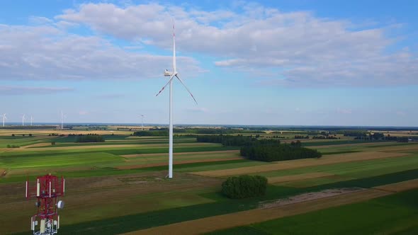 Aerial View of 5G Tower and Wind Energy Turbines in Summer