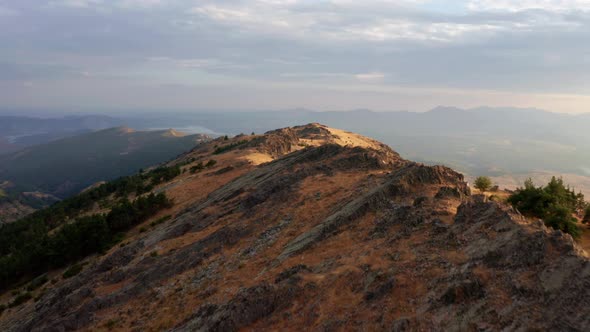 Hiker standing on ridge enjoying view to distance at sunset