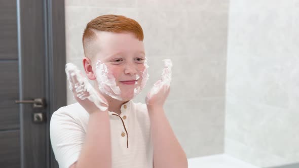 Funny Boy in the Bath Smears His Face with Shaving Cream the Child Imitates an Adult Dad Shaves