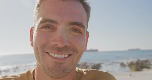 Portrait of young man on a beach smiling