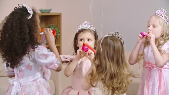 Kids Celebrating Birthday with Party Horns alt