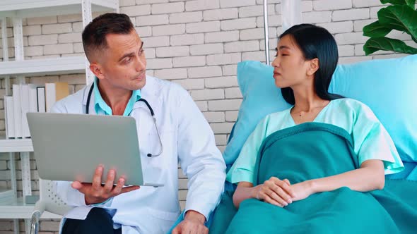 Doctor in Professional Uniform Examining Patient at Hospital