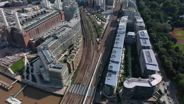 High Angle View of Train Driving on Multi Track Railway Line Leading Between Apartment Houses at