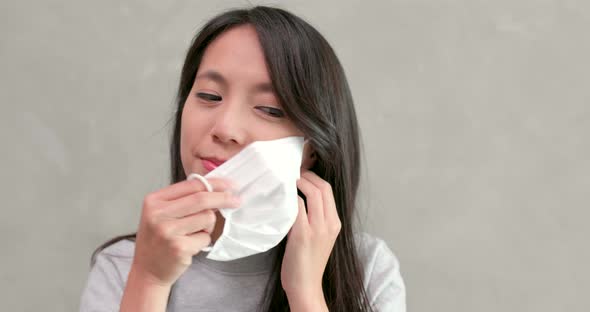 Woman Taking Off the Face Mask