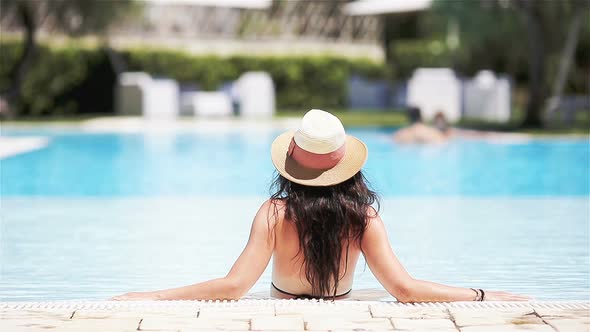Woman Relaxing By the Pool in a Luxury Hotel Resort Enjoying Perfect Beach Holiday Vacation