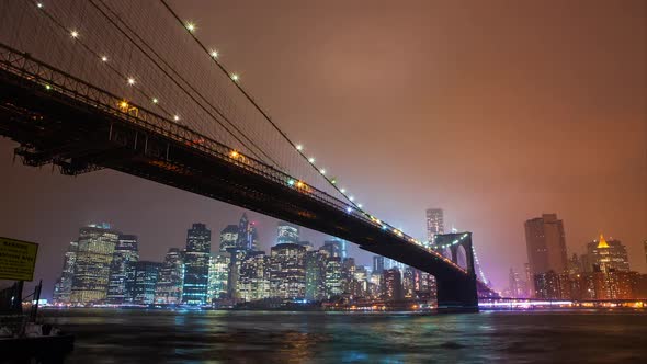 Time lapse of the Brooklyn Bridge overlooking the East River to Manhattan at night