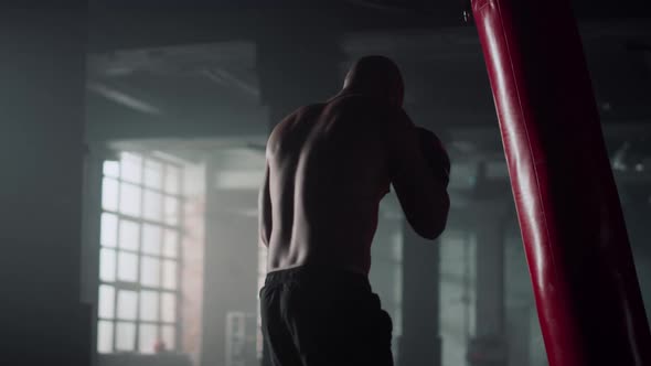 Boxer Hitting Punch Bag During Intense Workout