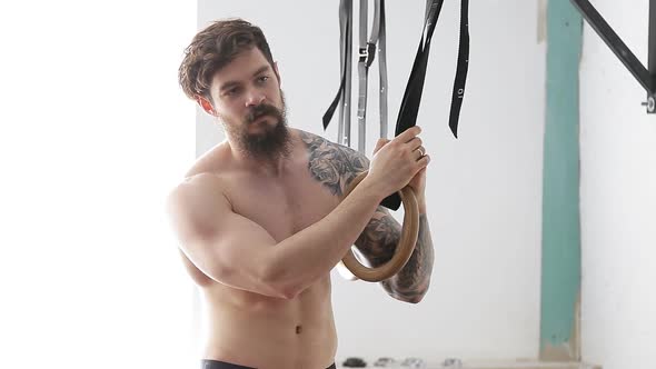 Man Doing Exercises on Gymnastic Rings. a Muscular Athlete for a Crossfit Workout.