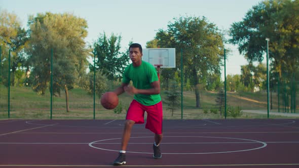 Streetball Player Dribbling Ball on Outdoor Court