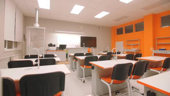 Student Workplaces with Faucets in Empty Chemistry Classroom alt