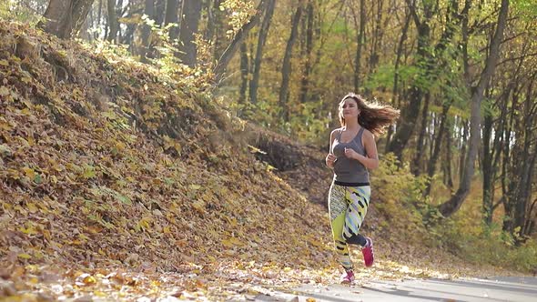 Runner woman running in autumn Park outdoor exercise, sports girl.