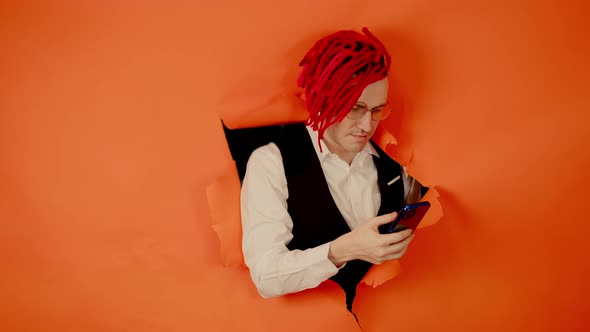 Man with Red Dreadlocks Using Smartphone