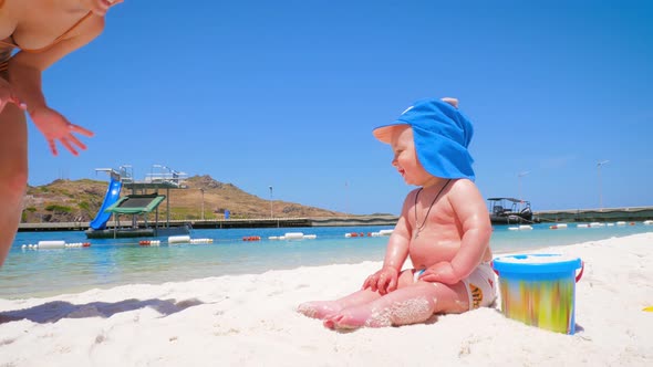 Emotions of a Little Happy Boy Who Is on the Beach for the First Time with Mom