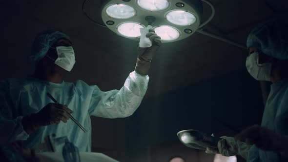 Doctor Adjusting Surgery Lights in Operating Room