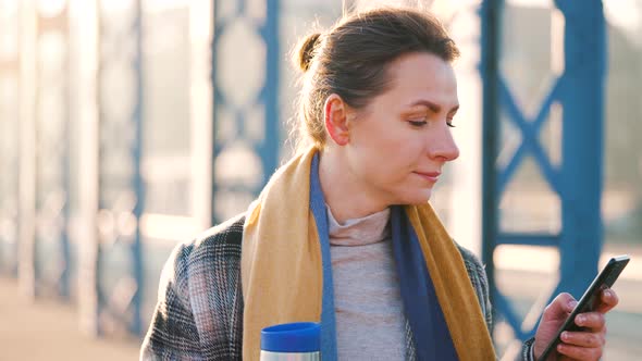 Portrait of a Young Caucasian Businesswoman in a Coat Walking Around the City on a Frosty Morning