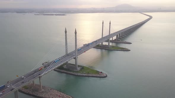 Aerial revealing shot car traffic cross the sea