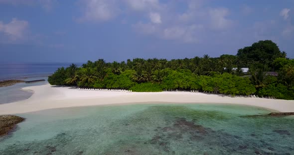 Wide drone tourism shot of a sunshine white sandy paradise beach and aqua blue water background in h