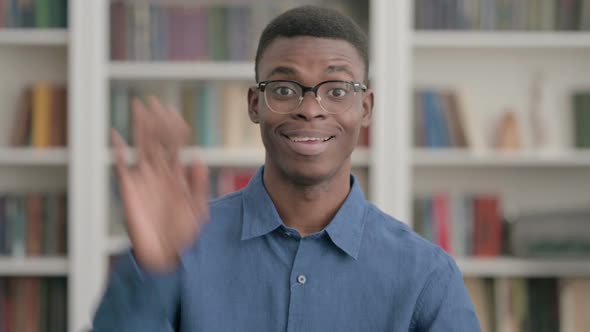 Young African Man Waving Welcoming