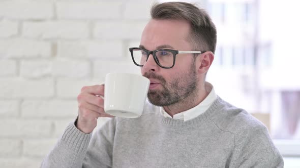 Young Designer Having Toothache While Drinking Coffee