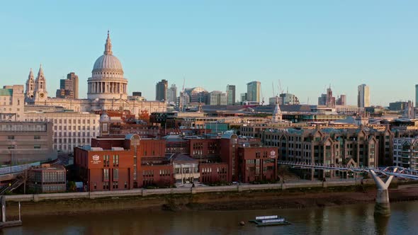 Low slider aerial of St Pauls Cathedral from the Thames at sunrise