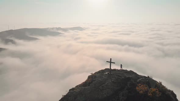 Aerial Rising View In Morning With Person Lookig Over Dramatic Cloudscape Panorama