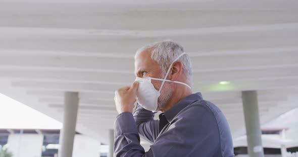 Caucasian man out and about in the street wearing on a face mask against coronavirus