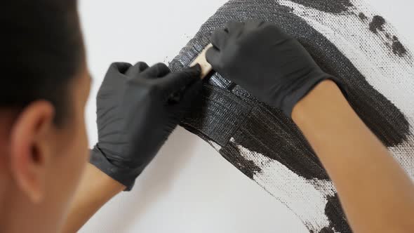 Artist in Black Gloves Draws Picture of Grey Colour Closeup