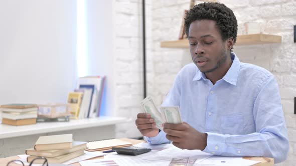 African Man Working With Money and Separating