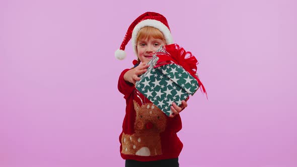 Happy Teen Toddler Girl Kid Wears Red Christmas Sweater Presenting Christmas Gift Box Shopping Sale