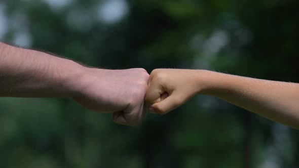 Man and Child Punching Fists, Parents as Reliable Support for Children, Closeup