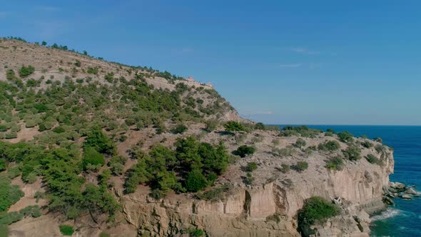 Aerial view of green hill and sea water landscape